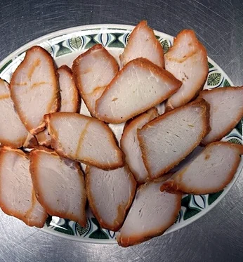 Sliced Bar-B-Q pork on a patterned plate