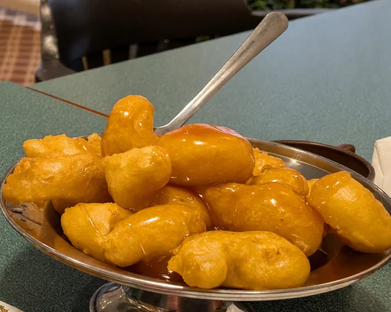 Chicken balls with sweet and sour sauce on a steel platter