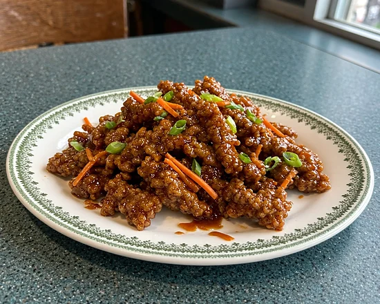 Crispy ginger stir fry with carrot strips and green onion