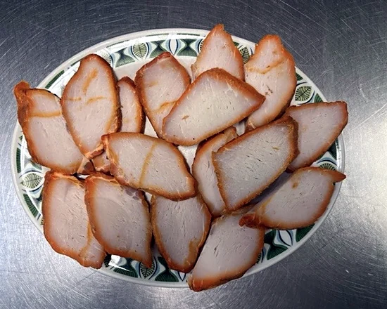 Sliced Bar-B-Q pork on a patterned plate